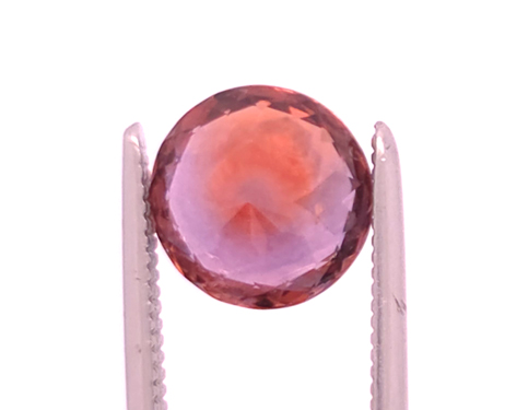 back of orangy pink Montana Sapphire